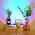 Robot Sunset Projection Lamp, rainbow sunset glow on a shelf