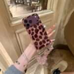 Purple Leopard Star iPhone Case with charm strap, lifestyle photo