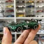Green GT3 race car diecast held in hand side view