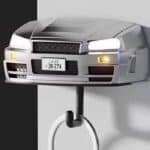 Silver R34-style sports car wall key holder with headlights on