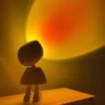 Robot Sunset Projection Lamp, warm sunset light in a dark room